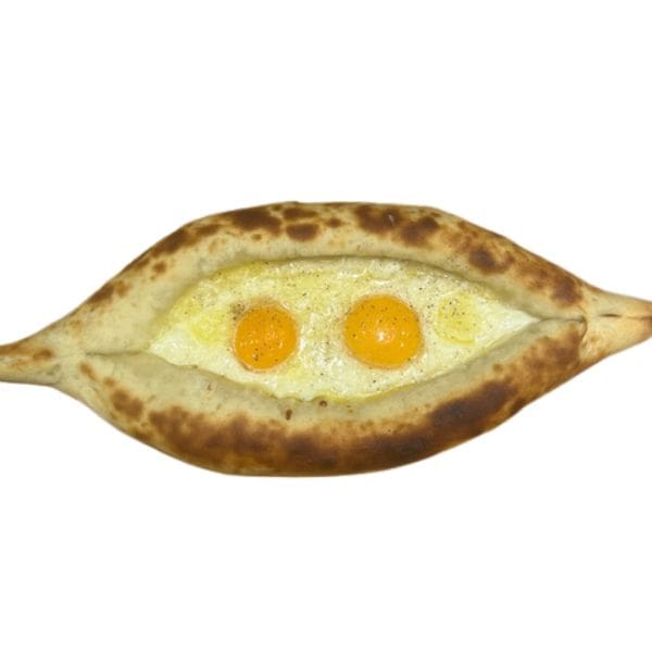 Ajarski Khachapuri bread boat with feta, mozzarella cheese, and two eggs on top